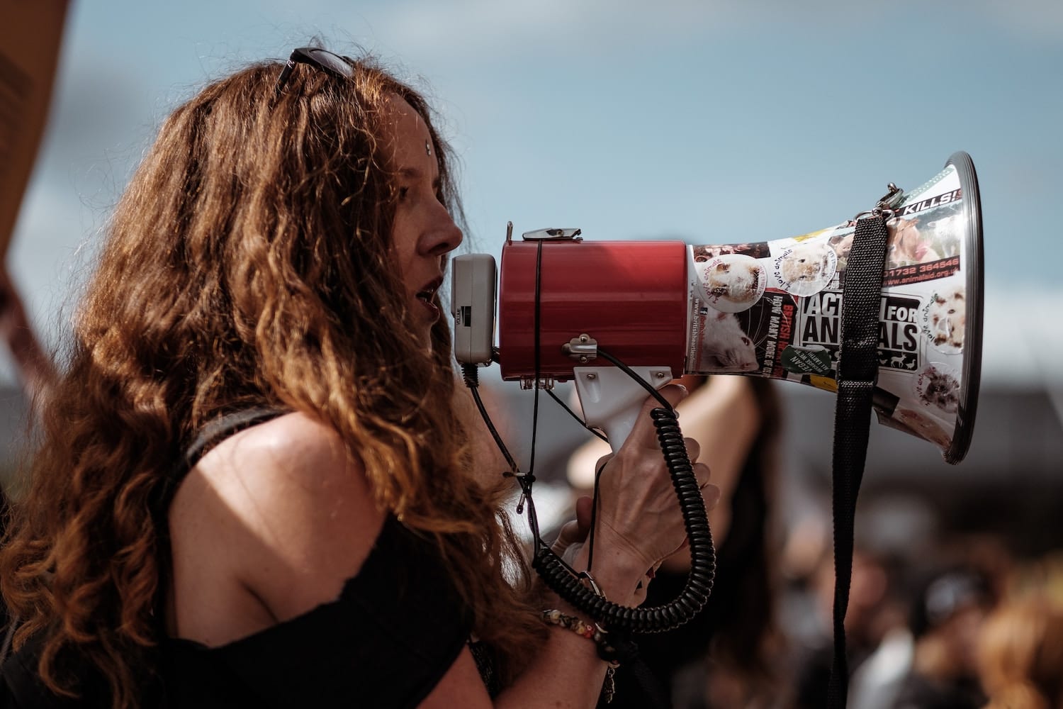 Political poet activist holding a megaphone at a rally.