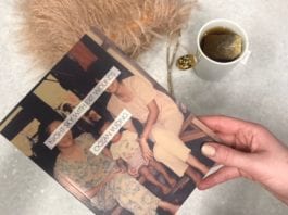 Hand holding Night Sky with Exit Wounds by Ocean Vuong with tea and fuzzy pillow