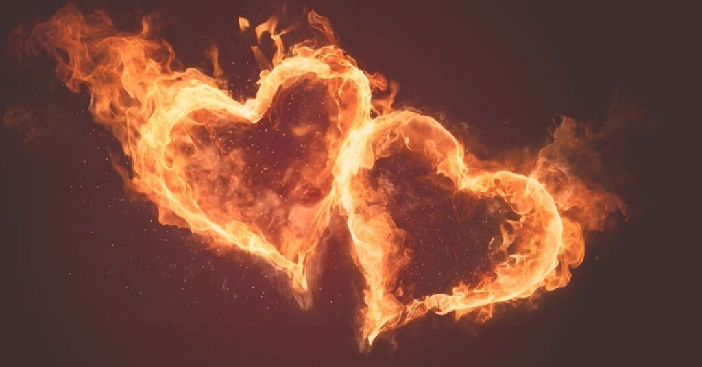 two hearts on fire on dark background