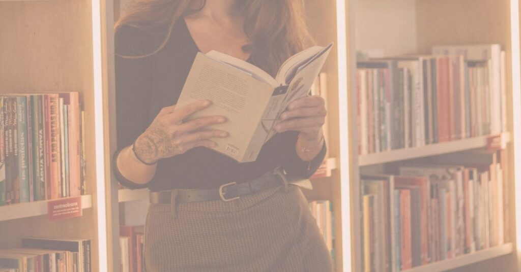 woman browsing romance novel in book store