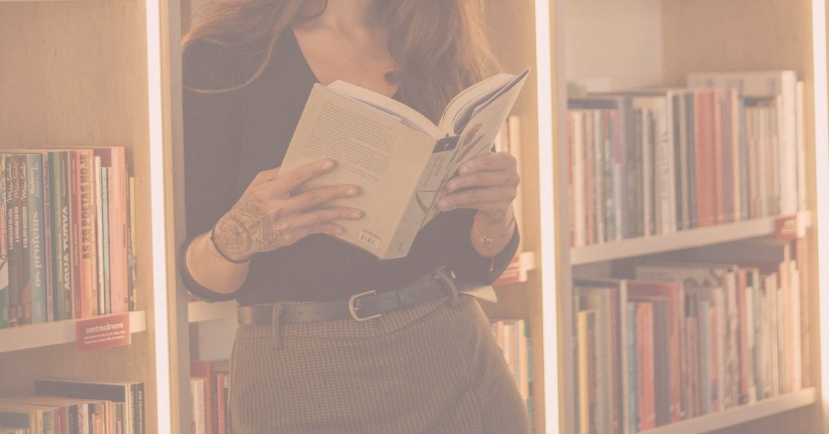 woman browsing romance novel in book store